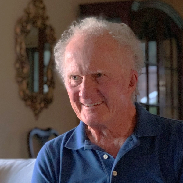 Garth M-person-smiling-with-white-hair person smiling with white hair and blue polo shirt
