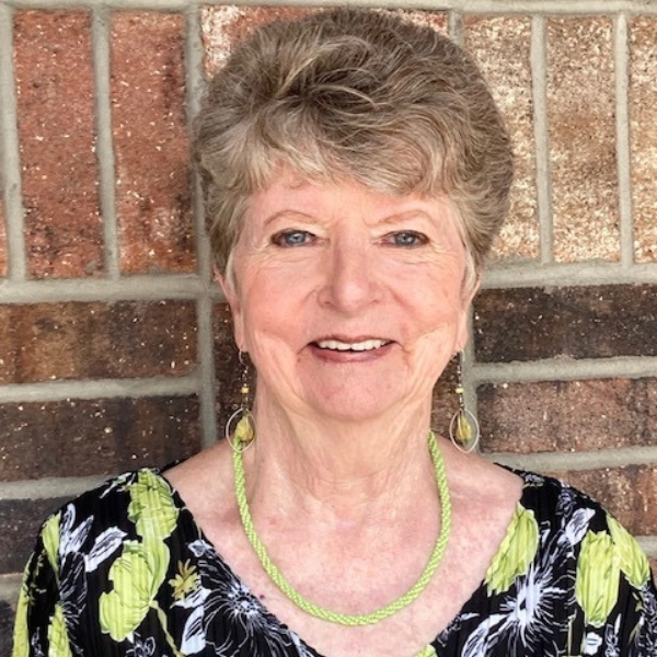 Kathleen B-person-smiling-wearing-long-earrings Person smiling, wearing black shirt and long earrings
