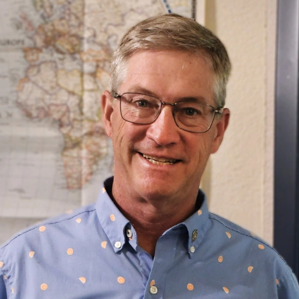 Randall Kurtz-person-smiling-wearing-glasses-and-blue-collared-shirt person smiling, wearing glasses and a blue collared shirt