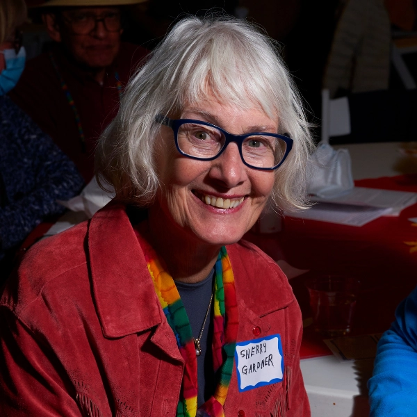 Sherry Gardner-person-smiling-wearing-glasses Person smiling, wearing red jacket and glasses