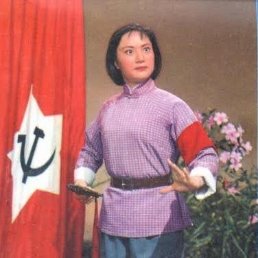 An actress looks valiantly ahead next to a Chinese communist party flag